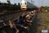 bvillagers_in_indonesia_have_resorted_to_lying_on_train_t_7.jpg